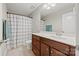 Neutral bathroom with a wooden vanity, and a shower-tub combination with a patterned curtain at 2322 Morrison Rd, York, SC 29745