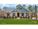 Charming brick home with blue siding and shutters, complemented by lush green lawn and landscaping at 2322 Morrison Rd, York, SC 29745