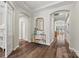 Elegant hallway featuring arched doorways, tray ceilings, hardwood floors, and decorative accents at 2322 Morrison Rd, York, SC 29745