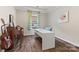 Bright home office with hardwood floors, a large white desk, and a peaceful view from the window at 2322 Morrison Rd, York, SC 29745