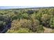 An aerial view of a house nestled in a dense forest, surrounded by lush greenery at 2514 King Arthur Dr, Monroe, NC 28110