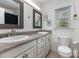 Bright bathroom featuring double sinks, granite counters, square mirrors and decorative fixtures at 2514 King Arthur Dr, Monroe, NC 28110