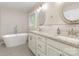 Bright bathroom featuring double sinks, granite counters and a soaking tub at 2514 King Arthur Dr, Monroe, NC 28110