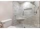 Stylish bathroom showcasing a glass shower with a built-in seat and modern fixtures at 2514 King Arthur Dr, Monroe, NC 28110