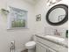 Cozy bathroom with granite counters, mosaic backsplash and decorative mirror at 2514 King Arthur Dr, Monroe, NC 28110