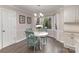 Charming dining area with light wood chairs, white table, and bay window with natural light at 2514 King Arthur Dr, Monroe, NC 28110