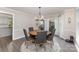 Elegant dining room featuring a round wood table, upholstered chairs, and decorative chandelier at 2514 King Arthur Dr, Monroe, NC 28110