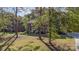 Beautiful brick home nestled among mature trees with manicured lawn at 2514 King Arthur Dr, Monroe, NC 28110
