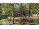 Two-story brick home with mature landscaping, a spacious front lawn, and great curb appeal at 2514 King Arthur Dr, Monroe, NC 28110