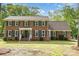 Charming two-story brick home with a well-maintained front lawn and mature trees in a desirable neighborhood at 2514 King Arthur Dr, Monroe, NC 28110