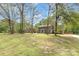 Well-maintained brick home with lush front yard, mature trees, and inviting curb appeal at 2514 King Arthur Dr, Monroe, NC 28110