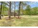 Charming two-story brick home with a well-manicured front lawn and mature trees at 2514 King Arthur Dr, Monroe, NC 28110