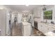 Spacious kitchen with white cabinets, granite countertops, stainless steel appliances, and hardwood floors at 2514 King Arthur Dr, Monroe, NC 28110