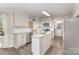 Bright kitchen with white cabinets, granite countertops, stainless steel appliances, and hardwood floors at 2514 King Arthur Dr, Monroe, NC 28110