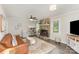 Inviting living room featuring stone fireplace, leather sofa, and hardwood floors at 2514 King Arthur Dr, Monroe, NC 28110