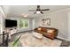 Comfortable living room featuring a leather sofa, decorative rug, and bright windows at 2514 King Arthur Dr, Monroe, NC 28110