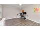 Bright home office with hardwood floors, ceiling fan, adjustable desk and modern office equipment at 2514 King Arthur Dr, Monroe, NC 28110