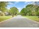 A quiet, tree-lined street in a residential neighborhood at 2514 King Arthur Dr, Monroe, NC 28110