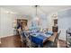 Bright dining room with hardwood floors, elegant lighting, and easy access to kitchen at 2739 Golden Rose Ln, Charlotte, NC 28216