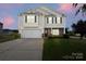 Charming two-story home with a well-manicured lawn and a two-car garage, captured at twilight at 2739 Golden Rose Ln, Charlotte, NC 28216