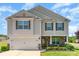 Charming two-story home with stone accents, a well-manicured lawn and a two-car garage at 2739 Golden Rose Ln, Charlotte, NC 28216