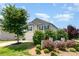 Beautifully landscaped yard with lush greenery, a charming two-story home, and a two-car garage at 2739 Golden Rose Ln, Charlotte, NC 28216