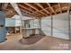 Unfinished basement featuring an exposed wooden ceiling and a garage door for potential car storage at 3015 North Center Nw St, Hickory, NC 28601