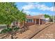 Charming brick home with a covered front porch, landscaped yard, and lush trees at 3015 North Center Nw St, Hickory, NC 28601