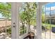 A sunroom featuring large glass windows and door, letting in ample light and views of the surrounding greenery at 3015 North Center Nw St, Hickory, NC 28601
