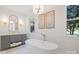 Bright bathroom with a freestanding tub, elegant fixtures, gray vanity and beautiful wallpaper at 356 Yacht Rd, Mooresville, NC 28117