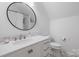 Well-lit bathroom features a sleek vanity, round mirror, modern fixtures, and a neutral color palette at 356 Yacht Rd, Mooresville, NC 28117