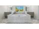 Bright bathroom featuring a large soaking tub, dual vanities, marble flooring and a scenic backyard view at 356 Yacht Rd, Mooresville, NC 28117
