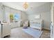 Bright Bedroom with water view, white crib, soft rug, and serene blue and white striped walls at 356 Yacht Rd, Mooresville, NC 28117