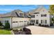 Elegant white home featuring a three-car garage, manicured landscaping, and inviting entrance at 356 Yacht Rd, Mooresville, NC 28117