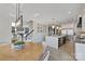 Open concept kitchen featuring a large island with seating, stainless steel appliances, and hardwood flooring at 356 Yacht Rd, Mooresville, NC 28117