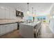 Elegant kitchen features a large island with seating, stainless steel appliances, and views of the water at 356 Yacht Rd, Mooresville, NC 28117