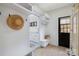 Bright mudroom with custom storage, bench, and stylish tile flooring leading to the utility room at 356 Yacht Rd, Mooresville, NC 28117