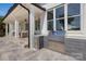 Outdoor kitchen with stainless steel grill, built-in storage, and a view of the covered patio area at 356 Yacht Rd, Mooresville, NC 28117