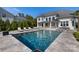 Backyard with pool, patio, lounge chairs, and outdoor kitchen, ideal for relaxation at 356 Yacht Rd, Mooresville, NC 28117