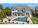 A stunning backyard oasis featuring a pool, spa, covered patio, and elegant outdoor furniture at 356 Yacht Rd, Mooresville, NC 28117