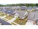 Aerial view of a neighborhood with well-manicured lawns, brick exteriors, and attached garages in a suburban setting at 3618 Marchers Trace Dr, Mint Hill, NC 28227