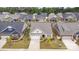 Aerial view of a beautifully landscaped property showcases its brick and siding design, well-kept lawn, and ample driveway at 3618 Marchers Trace Dr, Mint Hill, NC 28227