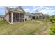 This backyard features a screened porch and an expansive lawn, perfect for outdoor activities at 3618 Marchers Trace Dr, Mint Hill, NC 28227