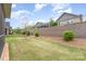 Spacious backyard with a retaining wall and wrought iron fence offering privacy and a well-manicured lawn at 3618 Marchers Trace Dr, Mint Hill, NC 28227