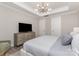Spacious bedroom with neutral tones, tray ceiling, a large bed, and a sleek dresser at 3618 Marchers Trace Dr, Mint Hill, NC 28227