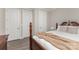 Comfortable bedroom featuring a well-crafted wooden bed frame and three white panel doors at 3618 Marchers Trace Dr, Mint Hill, NC 28227