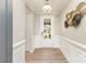 Inviting home foyer with light walls, elegant wall trim, modern lighting, and views of the outdoors at 3618 Marchers Trace Dr, Mint Hill, NC 28227