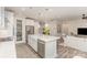 Bright and open kitchen with white cabinets, island, stainless steel appliances, and access to the living space at 3618 Marchers Trace Dr, Mint Hill, NC 28227