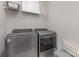 Modern laundry room showcasing front load washer and dryer with wire shelving at 3618 Marchers Trace Dr, Mint Hill, NC 28227
