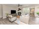 Cozy living room with neutral decor, fireplace, ceiling fan, and comfortable seating arrangement at 3618 Marchers Trace Dr, Mint Hill, NC 28227